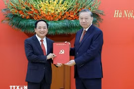 General Secretary of the Communist Party of Vietnam Central Committee To Lam (R) presents the Politburo's decision to General Trinh Van Quyet. (Photo: VNA)