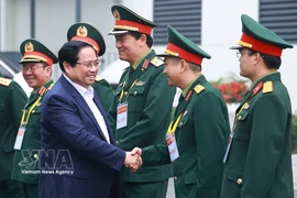 Prime Minister Pham Minh Chinh meets with leaders of the Viettel Military Industry and Telecoms Group. (Photo: VNA)