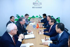Prime Minister Pham Minh Chinh meets with Uruguayan President Yamandú Orsi on the sidelines of the expanded BRICS Summit on July 7, 2025. (Photo: VNA) 