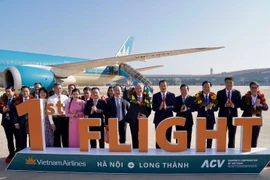 Vietnam Airlines's first passenger flight to Long Thanh carries Deputy Prime Minister Nguyen Hoa Binh (sixth from right) and nearly 100 passengers (Photo: VNA)