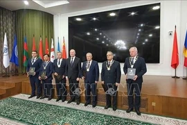 Professor and Academician Le Truong Giang (second from left) receives the Academician title from the International Association of Academies of Sciences on September 18. (Photo: VNA)