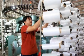 Producing silk thread for the textile industry in Binh Chanh district, Ho Chi Minh City. (Photo: VNA)
