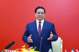 Prime Minister Pham Minh Chinh speaks at a meeting with leaders of Posts and Telecommunications Institute of Technology in Hanoi on April 24. (Photo: VNA)