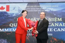 Ho Xuan Lam (right), Vice President and General Secretary of the HCM City Union of Friendship Organisations, presents flowers to congratulate Canadian Consul General Annie Dube at the event on July 2. (Photo: VNA)