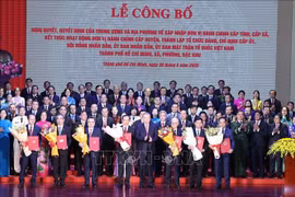 Party General Secretary To Lam (front, fifth from left) presents the resolutions and decisions on the merger of administrative units, the establishment of Party organisations, and the appointment of personnel at the ceremony in HCM City on June 30. (Photo: VNA)
