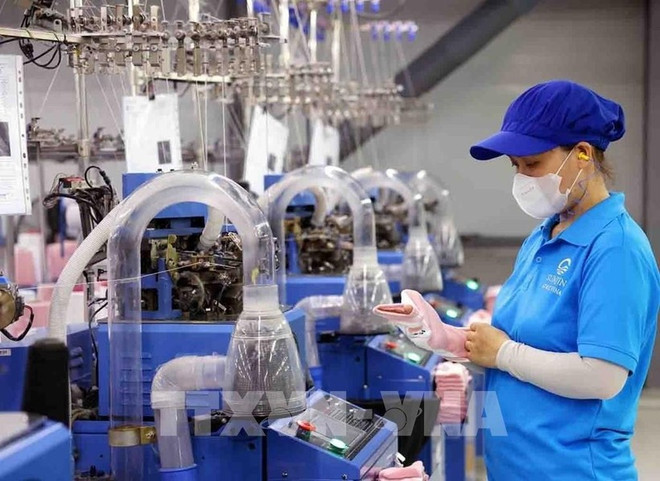 Sock production line for export at SUNJIN AT&C VINA Co., Ltd. in the Chan May - Lang Co economic zone, Hue city. (Photo: VNA) fdi-in-vietnam-1.jpg