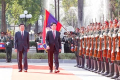 State President Luong Cuong (R) and General Secretary of the Lao People's Revolutionary Party (LPRP) Central Committee and President of Laos Thongloun Sisoulith review the guard of honour at the welcome ceremony on April 24 afternoon. (Photo: VNA)