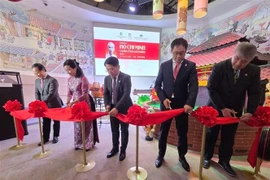 Delegates cut the ribbon to open the exhibition “President Ho Chi Minh – A Symbol of Peace and Friendship.” (Photo: VNA)