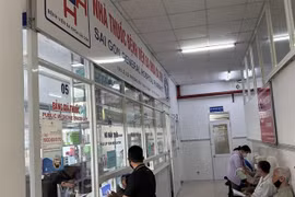 Patients with public health insurance receive medicine at a hospital in HCM City. (Photo: VNA)