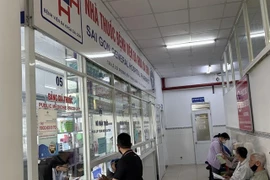 Patients with public health insurance receive medicine at a hospital in HCM City. (Photo: VNA)