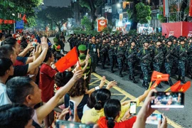 Parade contingents march along Kim Ma street during the state-level preliminary review on August 27 ahead of the official celebration on September 2. (Photo: VNA)