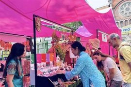 Visitors view accessories for ao dai (Vietnamese traditional dress) at an art programme at the HCM City Book Street in District 1 (Photo courtesy of Book Street Company)