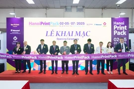Representatives of participating units cut the ribbon to open the exhibition. (Photo: VNA)