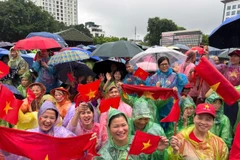 Braving the rain to watch National Day parade rehearsal