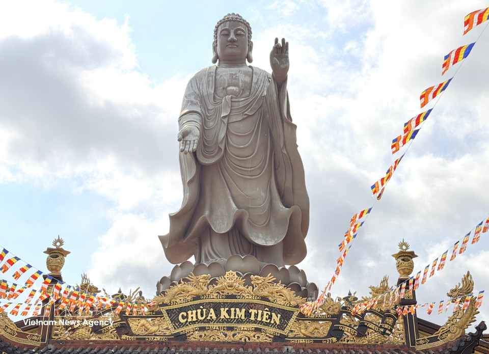 The 24-metre Amitabha Buddha statue stands majestically on the roof of Kim Tien Pagoda’s main hall. (Photo: VNA)