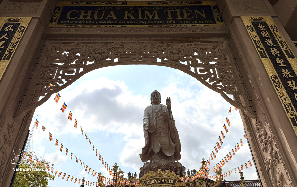 The 24-metre Amitabha Buddha statue atop the main hall, seen from the pagoda’s triple-arched gate. (Photo: VNA)