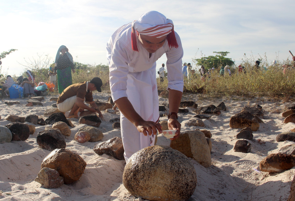 A ritual to purify the graves is performed before reciting prayers. (Photo: VNA)
