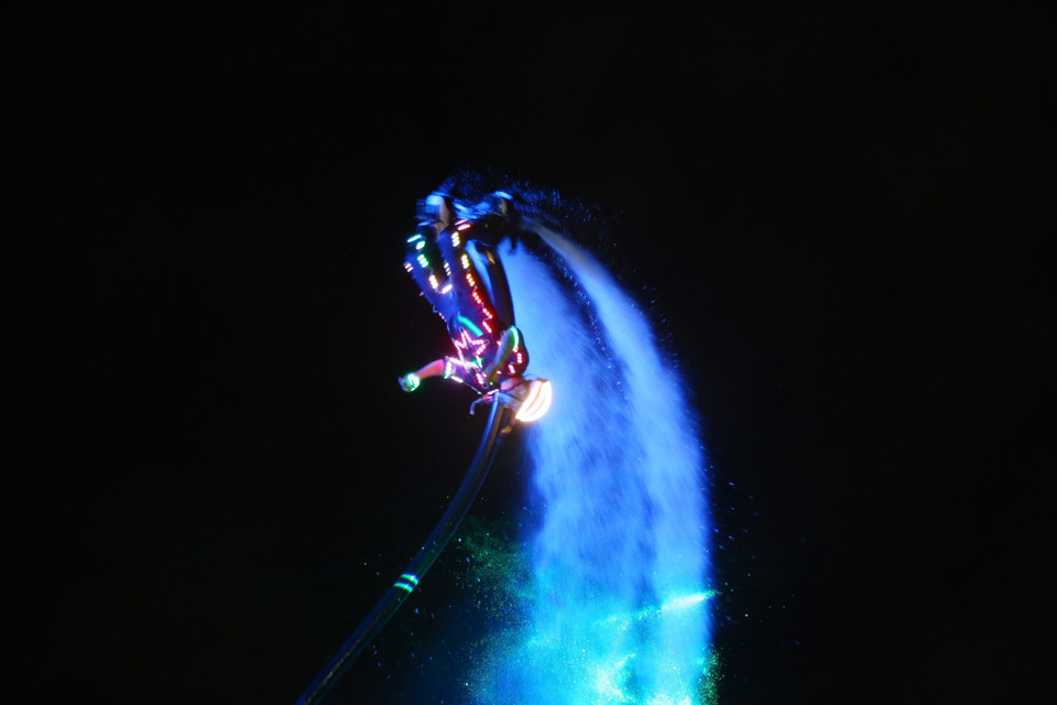 A flyboard athlete performs aerial flips powered by high-pressure water jets. (Photo: VNA)