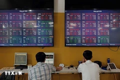 Customers trade at the head office of Bao Viet Securities Company in Hanoi. Photo: VNA