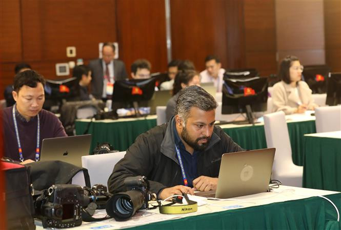 A foreign reporter covers the 13th Party Congress of the Communist Party of Vietnam at the event’s press centre (Photo: VNA)