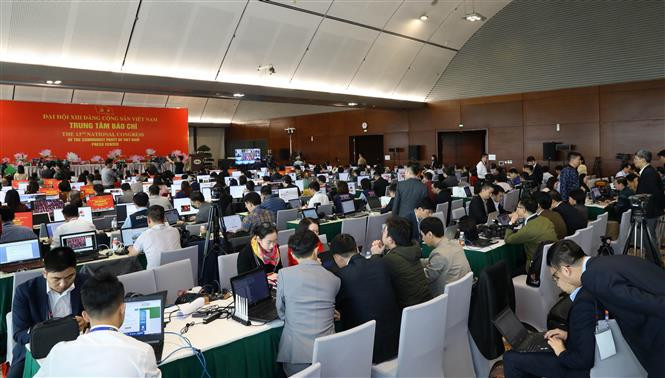 Reporters of local news agencies work at the press centre of the 13th National Party Congress (Photo: VNA)