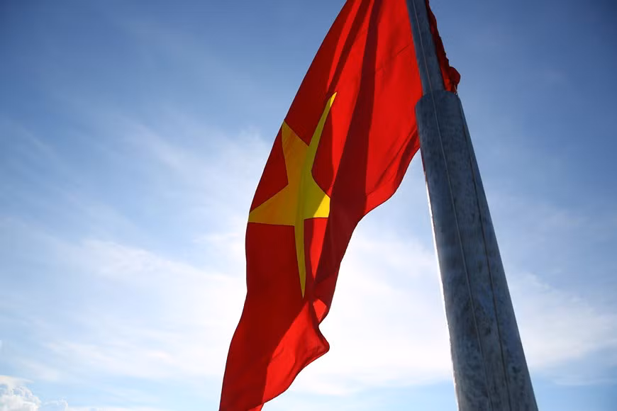The sacred national flag flaps in the sky. (Photo:Vietnamplus)