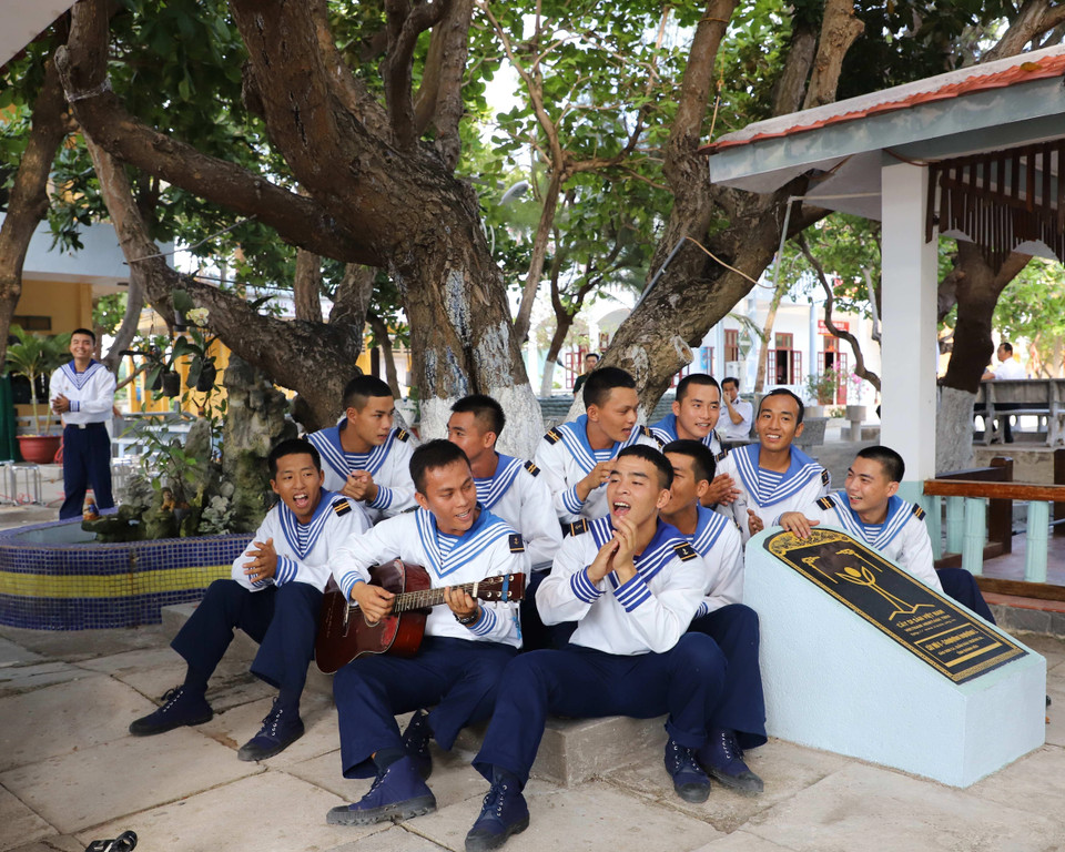 Soldiers on Son Ca island sing together under the trunk of the over-300-year-old Mu u or Calophylum, recognised as Vietnamese Heritage Tree. (Photo: VNA)