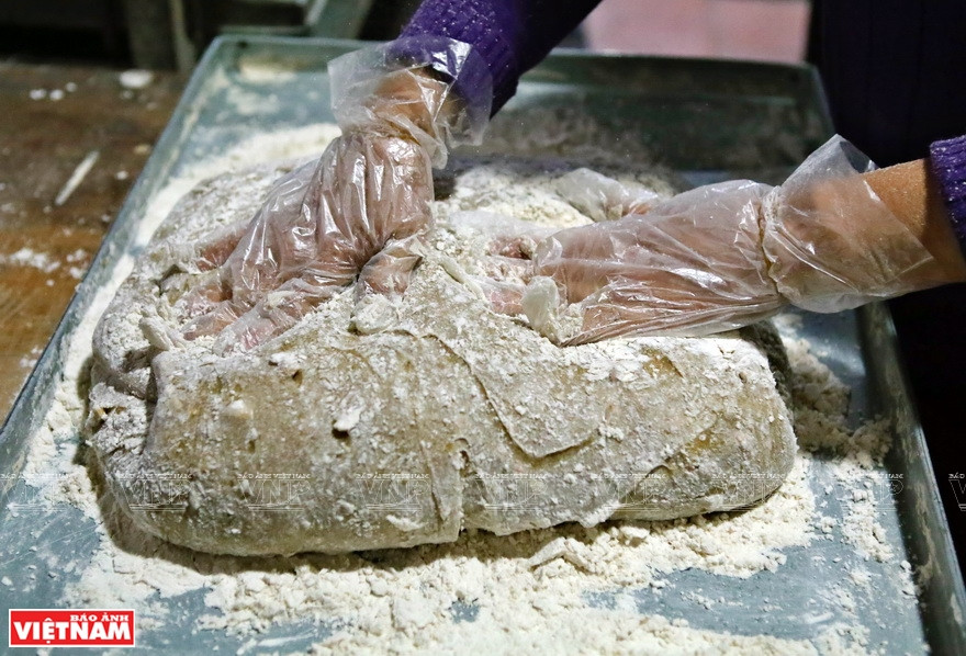Warm dough is kneaded well with some glutinous rice flour added (Photo: VNA) 