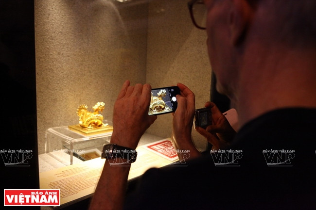 A foreign tourist takes photo of an exhibit. (Source: VNA)