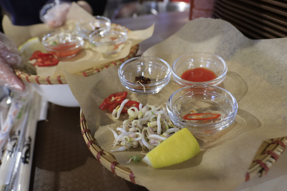 Spices served with beef noodle soup are carefully prepared. (Photo: VNA)
