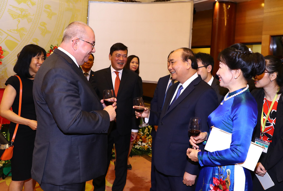 Prime Minister Nguyen Xuan Phuc and his spouse (R) warmly welcome foreign diplomats and international friends to the celebration (Photo: VNA)