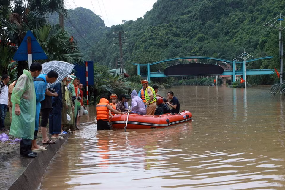 Rescue force helps locals move through inundated flooding areas (Photo: VNA)