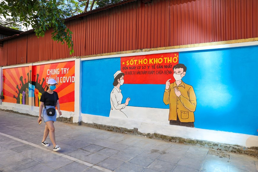 The 100-metre-long art work features 10 large paintings on COVID-19 prevention and control. (Photo: Vietnam+)