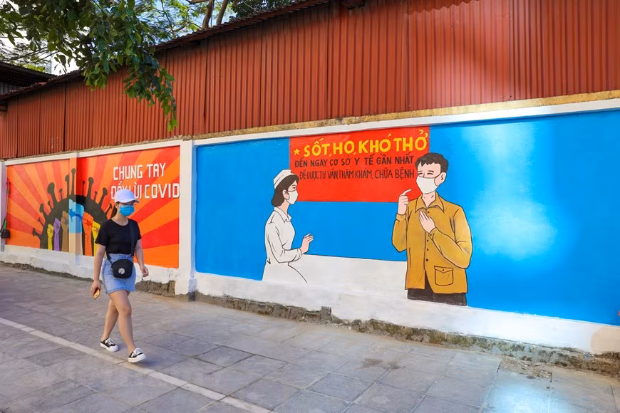 The 100-metre-long art work features 10 large paintings on COVID-19 prevention and control. (Photo: Vietnam+)