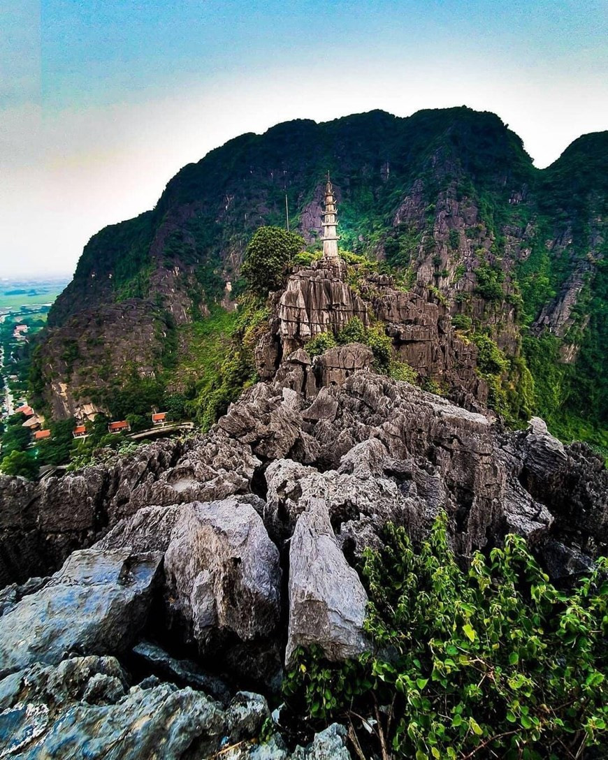 Trang An is of global significance as an outstanding humid tropical tower-karst landscape in the final stages of geomorphic evolution. It is composed of a variety of classical karst cones and towers and a network of enclosed depressions connected by an intricate system of subterranean waterways, some of which are navigable by small boats. The area is unique in having been invaded by the sea several times in the recent geological past but is now emergent on land. The blend of towering mountains draped in natural rain forest, with large internal basins and narrow cave passages containing quietly flowing waters, creates an extraordinarily beautiful and tranquil landscape. Archaeological deposits in caves reveal a regionally significant, continuous sequence of human occupation and utilization spanning more than 30,000 years. (Photo: Vietnamplus)