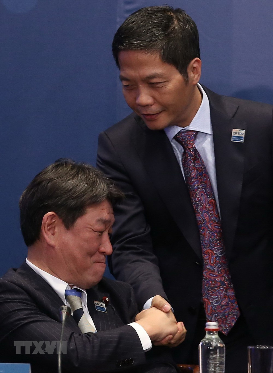 Vietnam's Minister of Industry and Trade Tran Tuan Anh (R) shakes hands with Japanese Minister of State for Economic and Fiscal Policy Toshimitsu Motegi at the signing ceremony. (Photo: VNA)