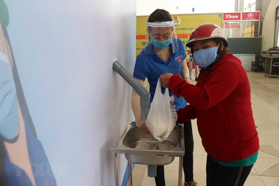 The poor in Binh Dinh province receive rice from the rice ATM site (Photo: VNA)