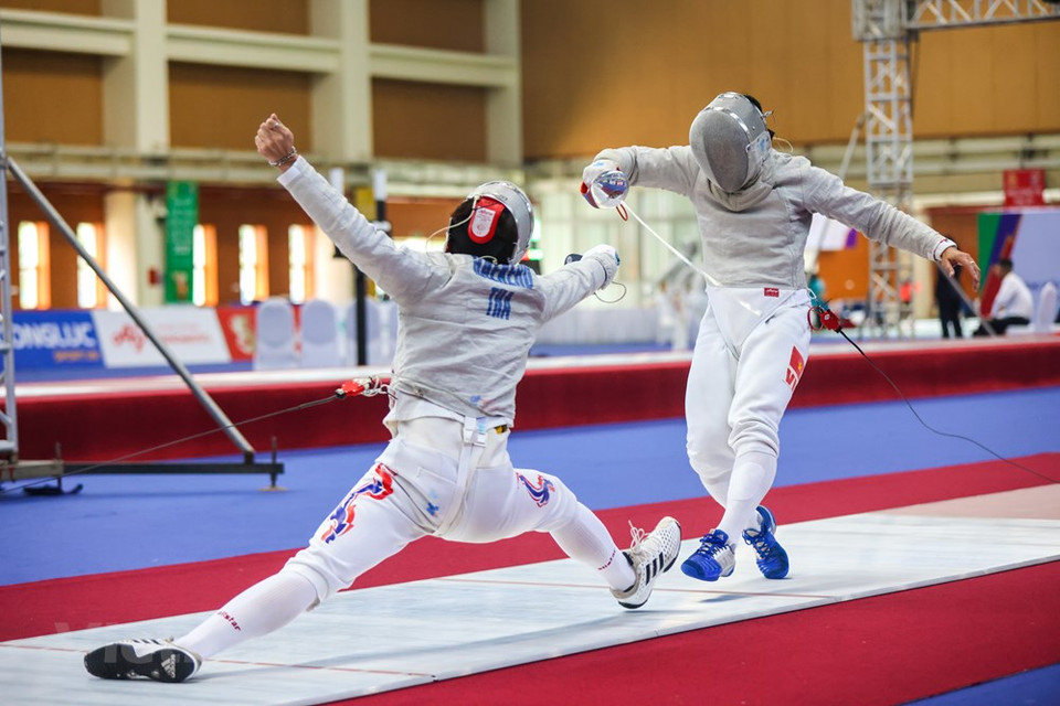 Fencer Vu Thanh An in the fight with his rival from Thailand. The reigning fencing champion flew the flag for Vietnam at the SEA Games while Olympic gold medalist Hoang Xuan Vinh lit the cauldron in Hanoi on May 12. It was An’s fifth time taking the honorable duty for the nation. He previously took the responsibility at the Rio Olympics in 2016, SEA Games 2017 and 2019 and the Asian Games in 2018. An is considered a “lucky” flag bearer as after his service, Vietnam won their first ever Olympic and Asian Games golds. At this year event, An is one of Vietnam’s golden hopes in men’s sabre fencing event. (Photo: VietnamPlus)