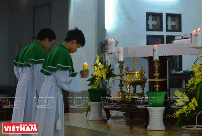 Acolytes offer candles on the altar before a service (Photo: VNA)
