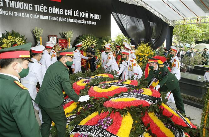 Honour guards cover the Former Party Leader Le Kha Phieu's grave with wreaths (Photo: VNA)
