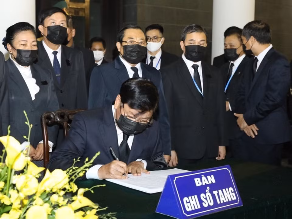 Lao Prime Minister Thongloun Sisoulith writes in the funeral book (Photo: VNA)
