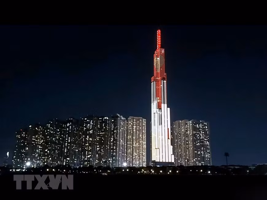 Vietnamese national flag with a heart symbol in the middle is lit up at Landmark 81 on Nguyen Huu Canh street in Binh Thuan district (Photo: VNA)