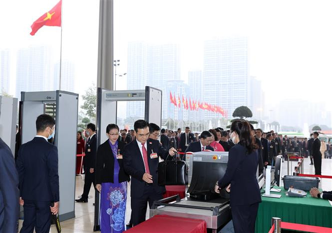 People in and out the National Convention Centre, the venue of the 13th National Party Congress, must go through security checks. (Photo: VNA)