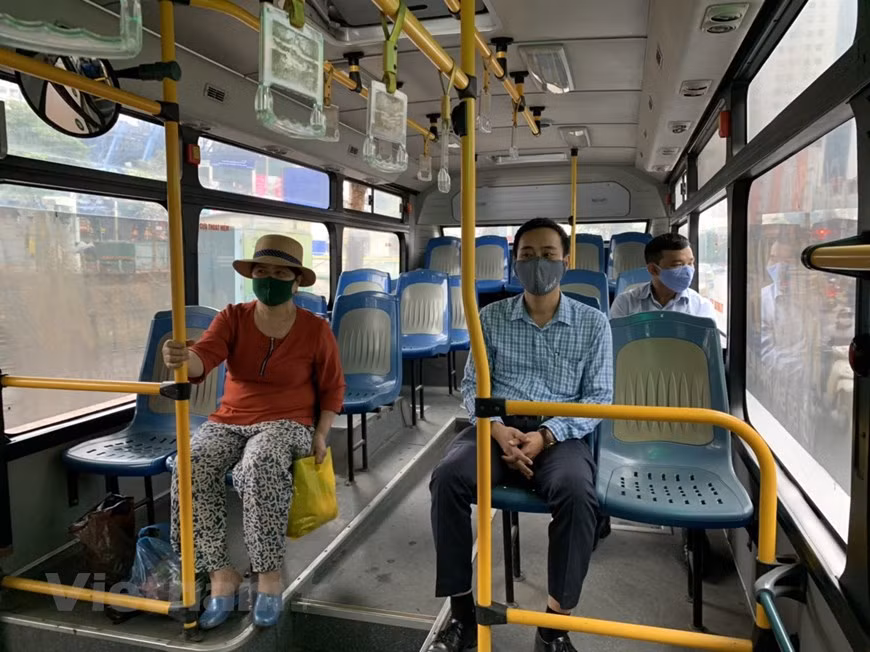 Passengers take their seat in accordance with social distancing regulation. However, there are very few passengers at the bus stations. The coronavirus epidemic has emptied buses and threatens job cuts across the transport sector as travel demand plummets. Many transport companies face the same dilemma, with the coronavirus dampening travel demand and hurting the logistics industry. Hanoi bus operators are slashing trips as business is hit by the novel coronavirus scare, restraining large numbers of people from traveling. The Hà Nội Transport Service Corporation (Transerco) has cut more than 7,500 bus trips per day, equivalent to nearly 80 per cent of the total trips amid the peak of COVID-19 in the capital city.(Photo: Viet Hung/Vietnamplus)