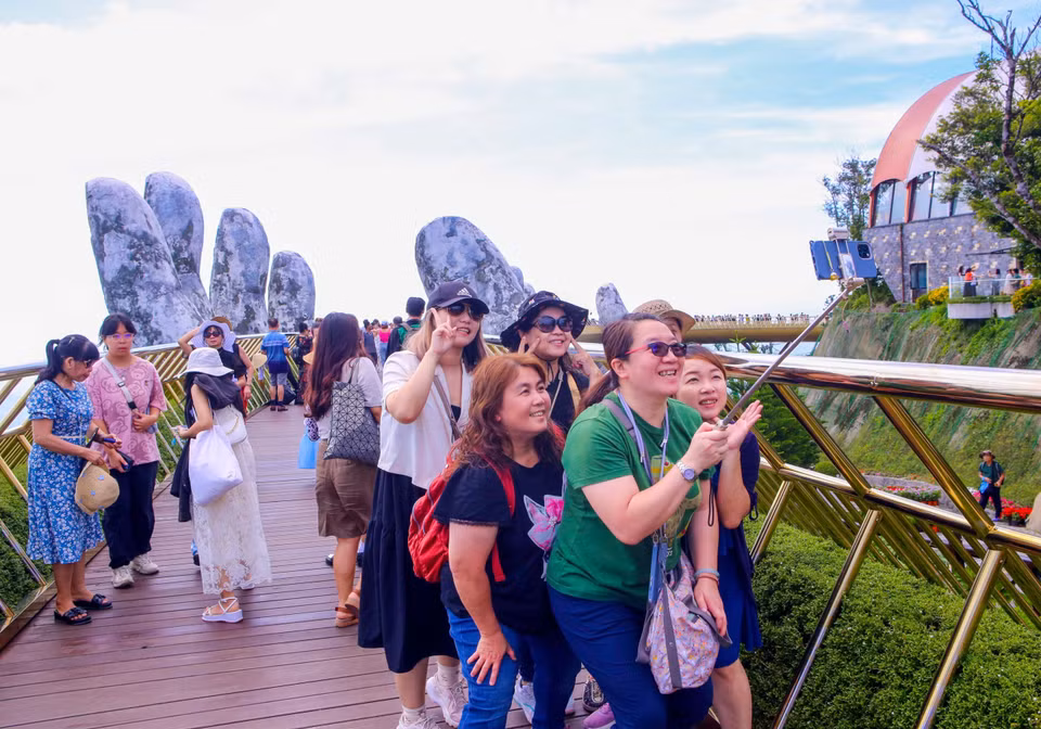 Foreign tourists visit the Golden Bridge at Sun World Ba Na Hills. (Photo: VNA)