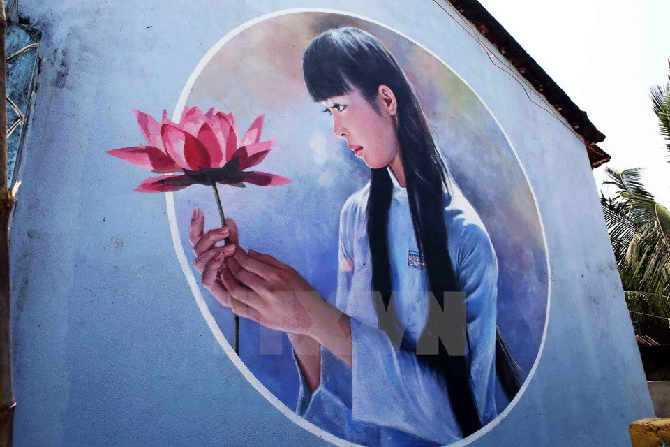 A young woman and lotus drawn by RoK painters (Photo: VNA)