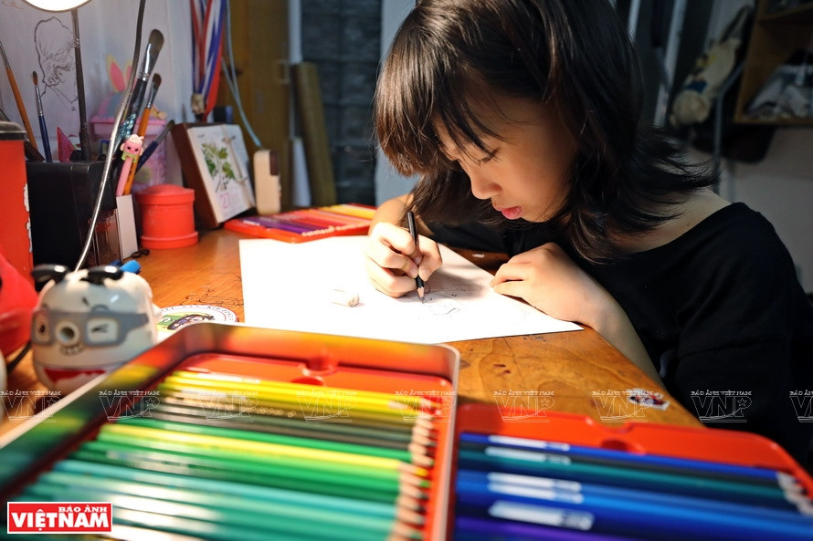 Nguyen Doi Chung Anh sketches her future artwork. (Photo: VNP/VNA)