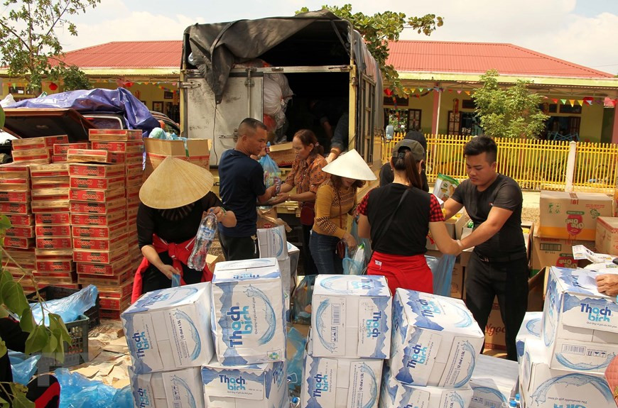 Relief teams gather essential supplies to deliver to isolated communes in Quang Ninh district, Quang Binh province (Photo: VNA)