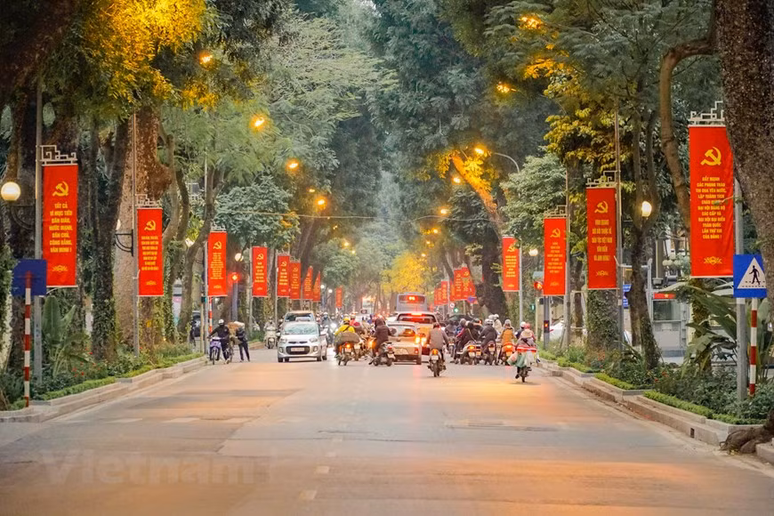 Streets become more vibrant than usual with flags, banners and flowers to welcome the 13th National Party Congress (Photo: Vietnam+)