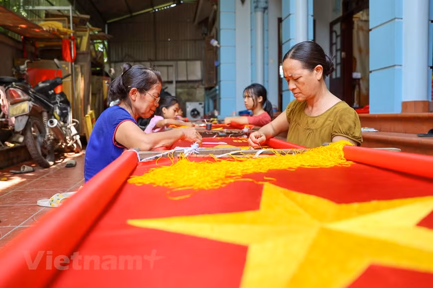 For a veteran embroiderer like Vuong Thi Nhung, it often takes between 3 and 5 days to complete embroidering a flag. For amateurs, it might take up to a week. Embroidering the national flag is a demanding job that requires a lot of finesses and meticulousness in every stitch, as the final products are for important events. Before coming into being, each flag experiences various steps, with the most important being the selecting of the fine materials. Embroidering the five-pointed golden star in the middle of the flag is the hardest as it is not easy to make the wings symmetrical. (Photo: VietnamPlus)